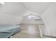 Cozy attic bedroom, illuminated by modern lighting with a comfortable bed and sleek vinyl floors at 4490 W Warm Springs Rd, Las Vegas, NV 89118