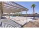 Covered patio overlooks the pool and backyard with desert landscaping at 4490 W Warm Springs Rd, Las Vegas, NV 89118