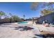 An expansive backyard with a covered patio and a sparkling pool, perfect for outdoor entertaining at 4490 W Warm Springs Rd, Las Vegas, NV 89118