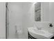 A clean bathroom featuring a toilet, sink, vanity and shower with marble surround at 4490 W Warm Springs Rd, Las Vegas, NV 89118