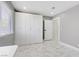 A bedroom featuring lots of closet space, a window with blinds, and marble floors at 4490 W Warm Springs Rd, Las Vegas, NV 89118
