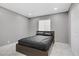 Modern bedroom with a minimalist aesthetic features a comfortable bed and marble floors at 4490 W Warm Springs Rd, Las Vegas, NV 89118