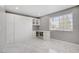 A bedroom featuring built-in cabinets, a built in desk, and stylish marble floors at 4490 W Warm Springs Rd, Las Vegas, NV 89118