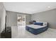 Spacious bedroom featuring a large sliding glass door leading to the backyard and marble floors at 4490 W Warm Springs Rd, Las Vegas, NV 89118