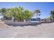 Charming home featuring a secure gated perimeter, mature trees, and ample yard space at 4490 W Warm Springs Rd, Las Vegas, NV 89118
