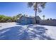 Home exterior featuring generous parking, secure fencing, and mature landscaping at 4490 W Warm Springs Rd, Las Vegas, NV 89118