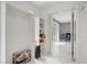 Bright hallway with a closet, shelving, and marble floors leads to a light filled room at 4490 W Warm Springs Rd, Las Vegas, NV 89118