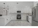 Bright and modern kitchen with white cabinets and stainless steel appliances at 4490 W Warm Springs Rd, Las Vegas, NV 89118