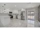 Modern open kitchen boasts stainless appliances, white cabinets, and a bright breakfast bar at 4490 W Warm Springs Rd, Las Vegas, NV 89118