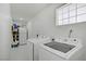Laundry room with tiled floors, washer, dryer and refrigerator at 4490 W Warm Springs Rd, Las Vegas, NV 89118
