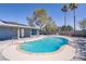 The private pool is surrounded by mature trees and desert landscaping at 4490 W Warm Springs Rd, Las Vegas, NV 89118
