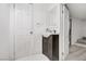 Cozy powder room with a dark vanity, basin sink, decorative mirror, and neutral walls, enhancing the home's aesthetic at 4490 W Warm Springs Rd, Las Vegas, NV 89118
