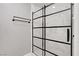 Modern glass shower with sleek black trim and beautiful white marble tiled walls, enhancing the bathroom's appeal at 4490 W Warm Springs Rd, Las Vegas, NV 89118