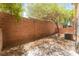 Fully fenced backyard with mature tree and desert landscaping at 455 Westminster Hall Ave # 101, North Las Vegas, NV 89032