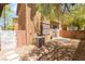 Landscaped backyard with trees, brick wall, and concrete paver patio at 455 Westminster Hall Ave # 101, North Las Vegas, NV 89032