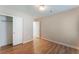 Spacious bedroom with wood-look floors, closet, and white trim at 455 Westminster Hall Ave # 101, North Las Vegas, NV 89032