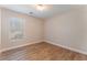 Bedroom with wood-look floors and a window letting in natural light at 455 Westminster Hall Ave # 101, North Las Vegas, NV 89032
