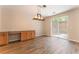 Open-concept dining area featuring stylish flooring, custom wood cabinets and access to the backyard at 455 Westminster Hall Ave # 101, North Las Vegas, NV 89032