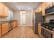Bright kitchen features stainless steel appliances, wood cabinets and modern recessed lighting at 455 Westminster Hall Ave # 101, North Las Vegas, NV 89032