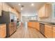 Bright kitchen features stainless steel appliances, wood cabinets and modern recessed lighting at 455 Westminster Hall Ave # 101, North Las Vegas, NV 89032