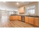 Bright kitchen features stainless steel appliances, wood cabinets and modern recessed lighting at 455 Westminster Hall Ave # 101, North Las Vegas, NV 89032