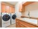 Convenient laundry room with washer, dryer, sink, granite counters and ample cabinet space at 455 Westminster Hall Ave # 101, North Las Vegas, NV 89032
