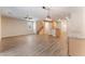 Bright open-plan living space featuring wood-look floors, modern lighting, and staircase at 455 Westminster Hall Ave # 101, North Las Vegas, NV 89032