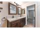 Nicely appointed bathroom featuring granite counters, dual sinks, and decorative mirrors at 455 Westminster Hall Ave # 101, North Las Vegas, NV 89032