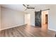 Large primary bedroom featuring a barn door and wood-look flooring at 455 Westminster Hall Ave # 101, North Las Vegas, NV 89032