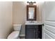 Stylish powder room featuring a dark vanity, white countertop, and modern fixtures at 455 Westminster Hall Ave # 101, North Las Vegas, NV 89032