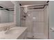 Bathroom featuring vanity with white countertop and shower with glass door and tile surround at 4742 Obannon Dr # A, Las Vegas, NV 89102