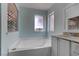 Bathroom featuring a tub with shower fixture and white vanity at 4742 Obannon Dr # A, Las Vegas, NV 89102