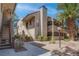Charming condo exterior with landscaped grounds, stucco facade, and a beautiful palm tree at 4742 Obannon Dr # A, Las Vegas, NV 89102