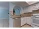 Bright kitchen featuring white cabinetry, tile backsplash, and stainless steel appliances at 4742 Obannon Dr # A, Las Vegas, NV 89102