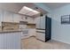 Well-lit kitchen with white cabinets, modern appliances, and tile flooring at 4742 Obannon Dr # A, Las Vegas, NV 89102