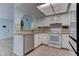 Bright kitchen featuring white cabinetry, tile backsplash, and stainless steel appliances at 4742 Obannon Dr # A, Las Vegas, NV 89102