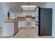 Well-lit kitchen featuring white cabinetry, tile backsplash, and stainless steel appliances at 4742 Obannon Dr # A, Las Vegas, NV 89102