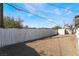 A spacious, low-maintenance backyard featuring gravel cover, a white fence, and a storage shed at 5069 Hallet Dr, Las Vegas, NV 89122