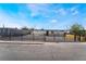 Charming single-story home with a black metal fence and gravel landscaping for a modern look at 5069 Hallet Dr, Las Vegas, NV 89122