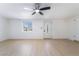 Bright living room features light hardwood floors, ceiling fan, and a glass paneled front door at 5069 Hallet Dr, Las Vegas, NV 89122
