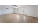 Bright living room with light hardwood floors, ceiling fan, and a glass paneled front door at 5069 Hallet Dr, Las Vegas, NV 89122