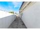 The side yard features a freshly painted white fence and ample space at 5069 Hallet Dr, Las Vegas, NV 89122