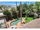 Backyard featuring a lagoon style pool surrounded by lush landscaping and towering trees at 5260 N Jones Blvd, Las Vegas, NV 89130
