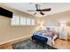 This cozy bedroom features carpet, a ceiling fan, and large windows at 5260 N Jones Blvd, Las Vegas, NV 89130
