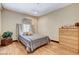 Cozy bedroom with hardwood flooring, air conditioner, and wooden dresser at 5260 N Jones Blvd, Las Vegas, NV 89130