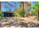 A long driveway leads to a charming garage, set amidst mature trees and lush landscaping at 5260 N Jones Blvd, Las Vegas, NV 89130