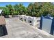 Aerial view of a property with white stucco buildings, garage, and ample parking space under a clear blue sky at 5260 N Jones Blvd, Las Vegas, NV 89130