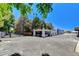 Wide aerial shot of property featuring a white building, secure fencing, and a large parking area on a sunny day at 5260 N Jones Blvd, Las Vegas, NV 89130