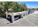 Aerial view featuring a white building with a tile roof, surrounded by ample parking and mature trees under a clear sky at 5260 N Jones Blvd, Las Vegas, NV 89130