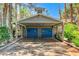 Covered garage with blue doors, set amidst mature trees and lush landscaping at 5260 N Jones Blvd, Las Vegas, NV 89130